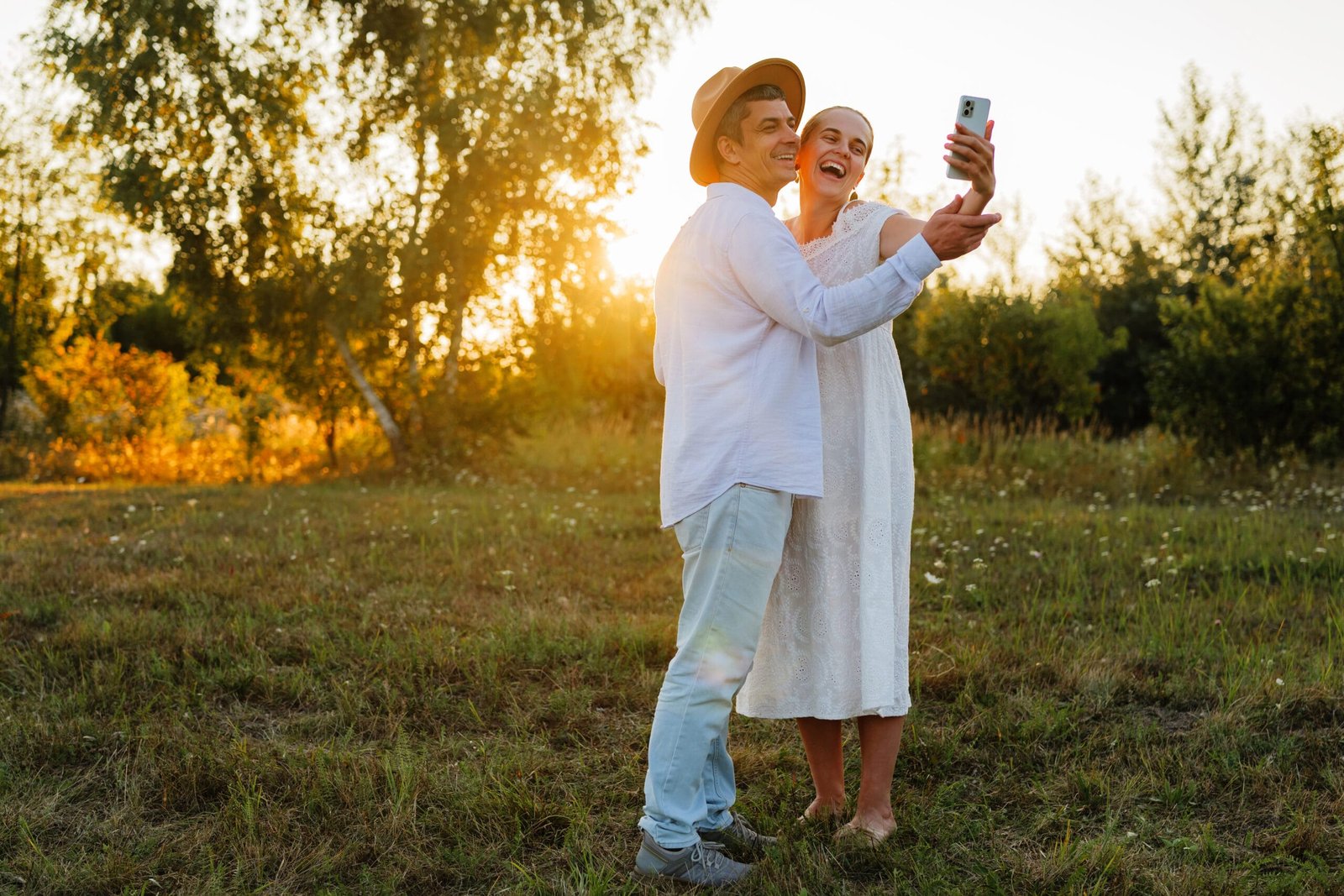 Older couple taking a photograph together outdoors
