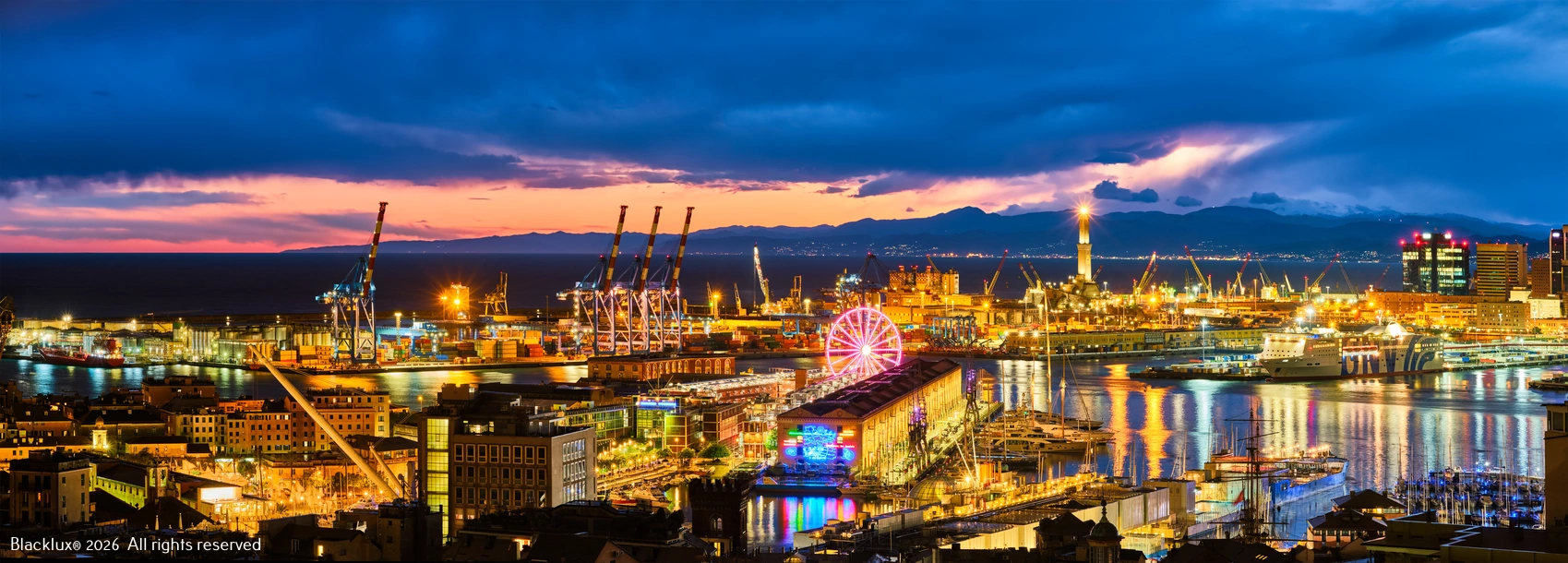 Panoramic Genoa harbour at blue hour with cranes, waterfront lights and a Ferris wheel