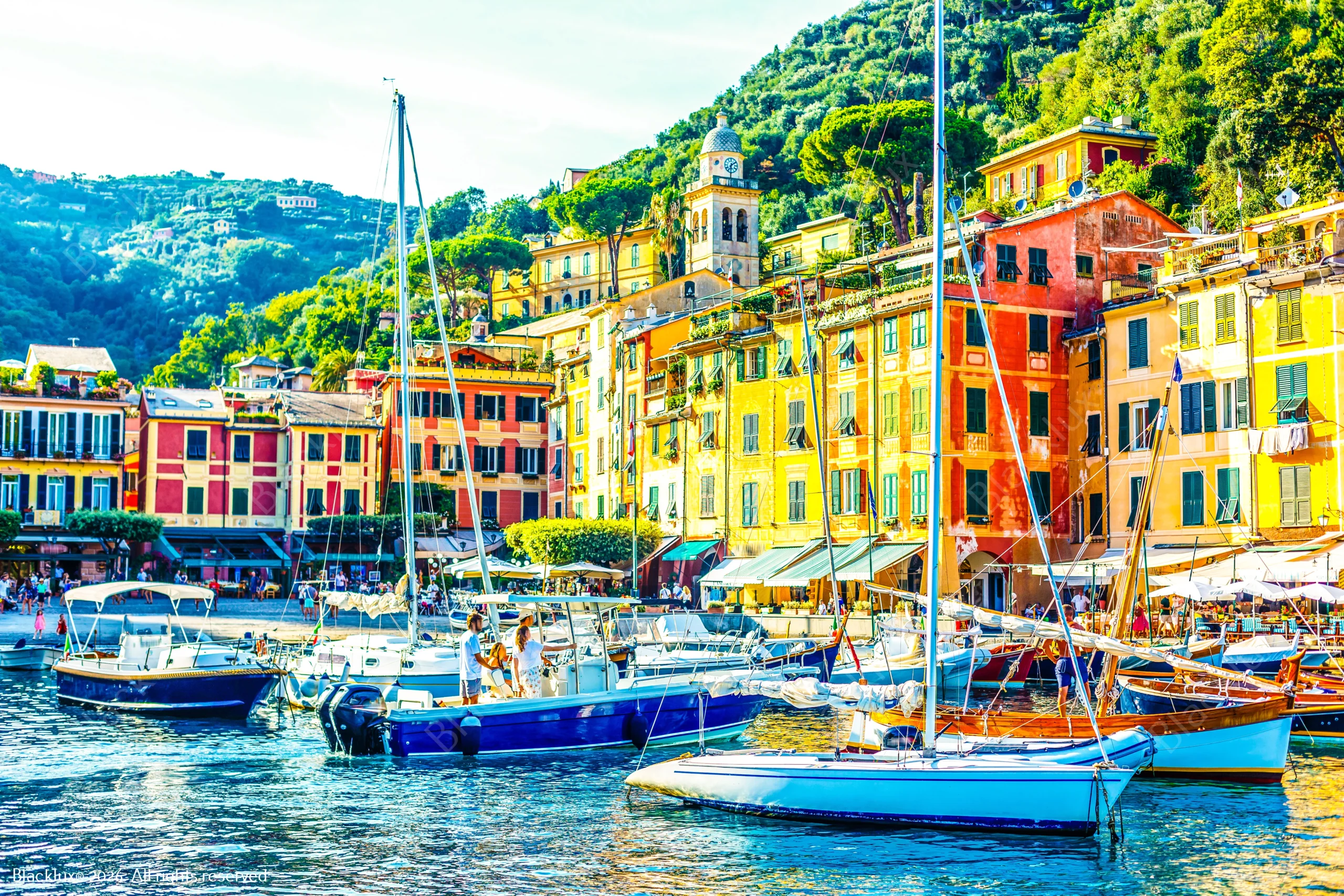 Colourful Portofino waterfront buildings behind moored small boats