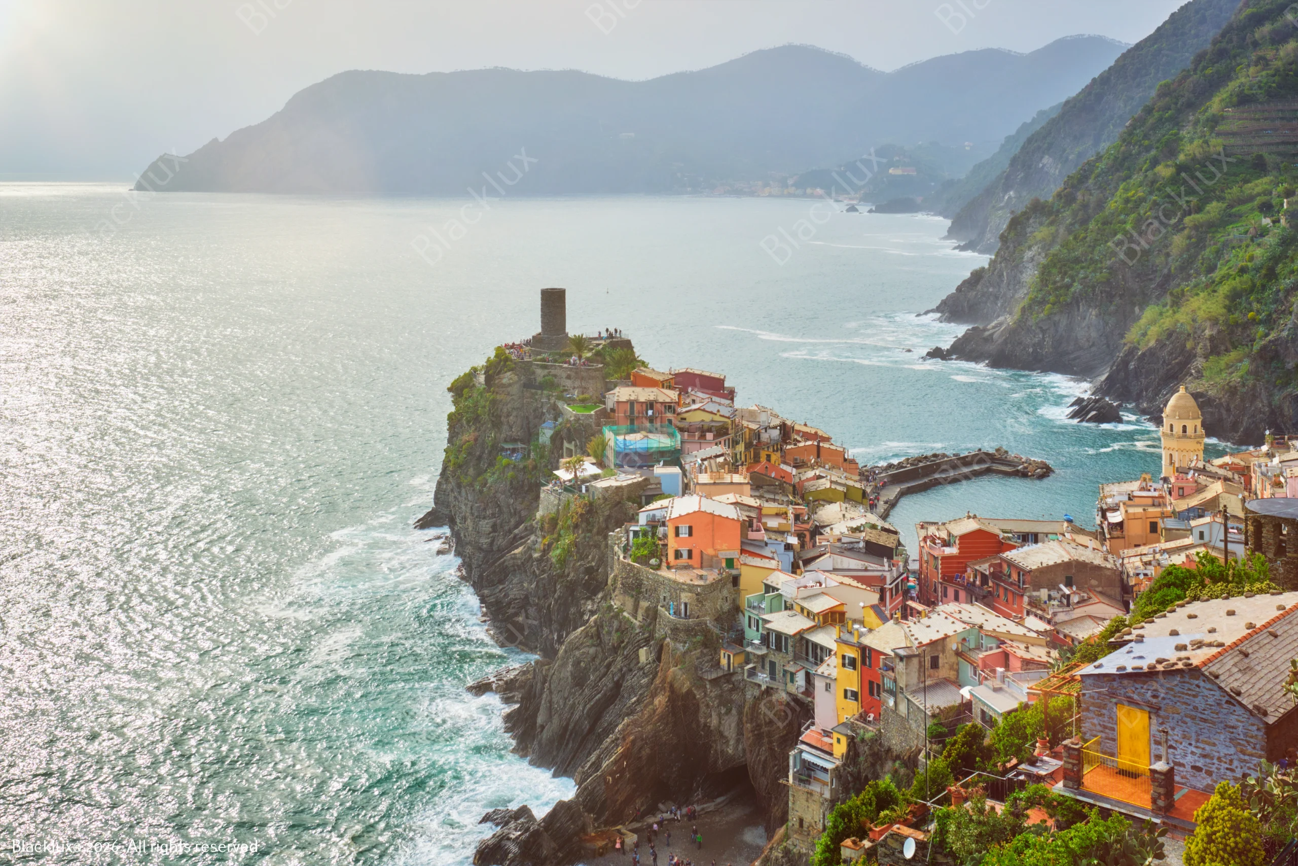 Daylight panorama of Vernazza with its harbour, church, castle tower and terraced coastline