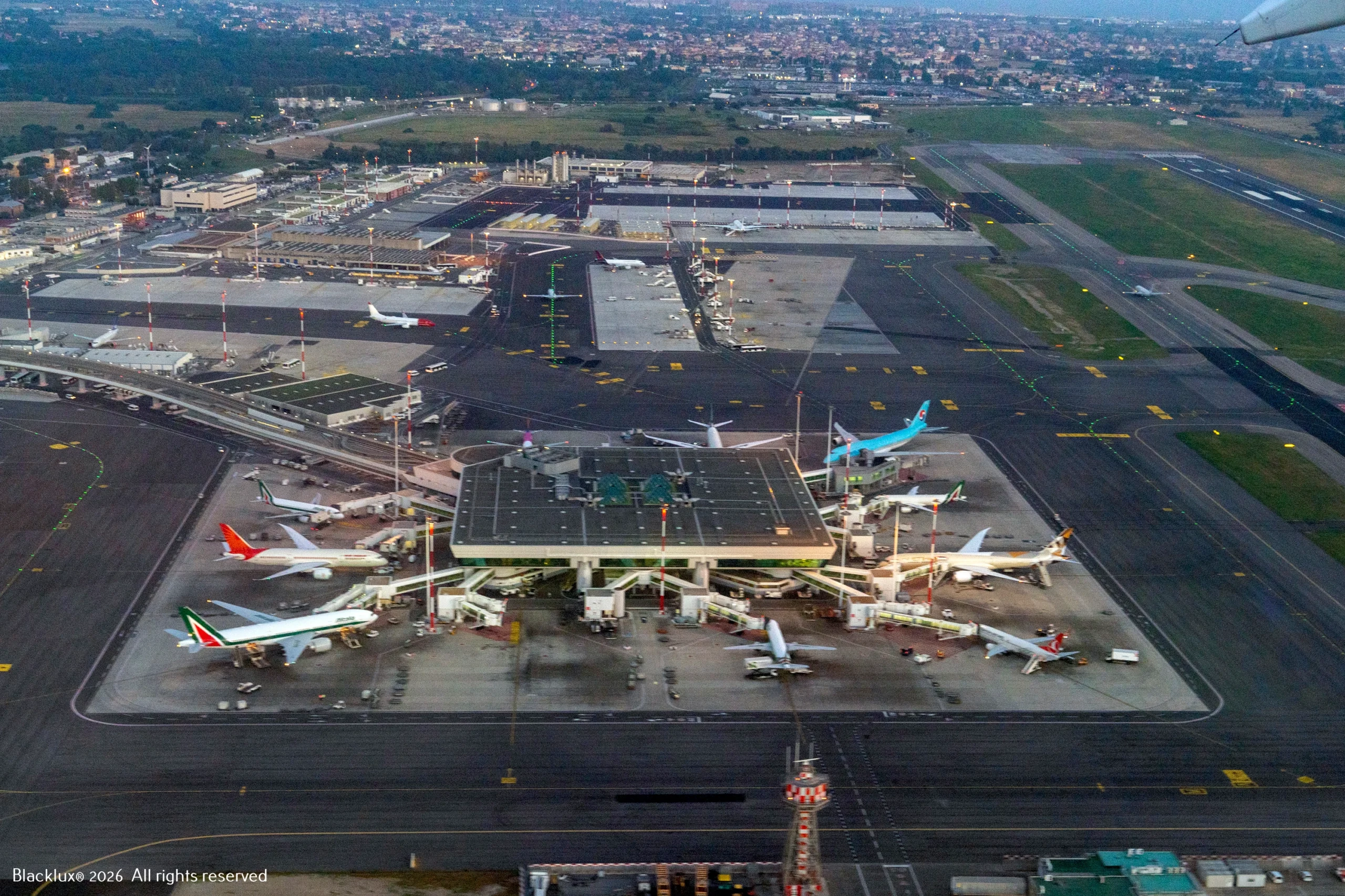 Aerial view of an airport terminal, apron and aircraft stands
