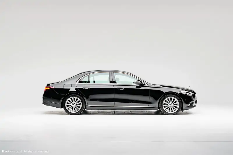 Black business sedan shown in full side profile in a light grey studio