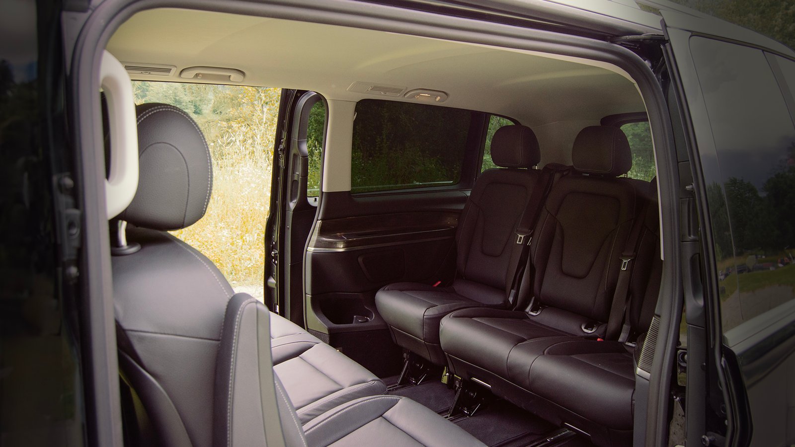 Brown passenger seats inside a van viewed through the side opening