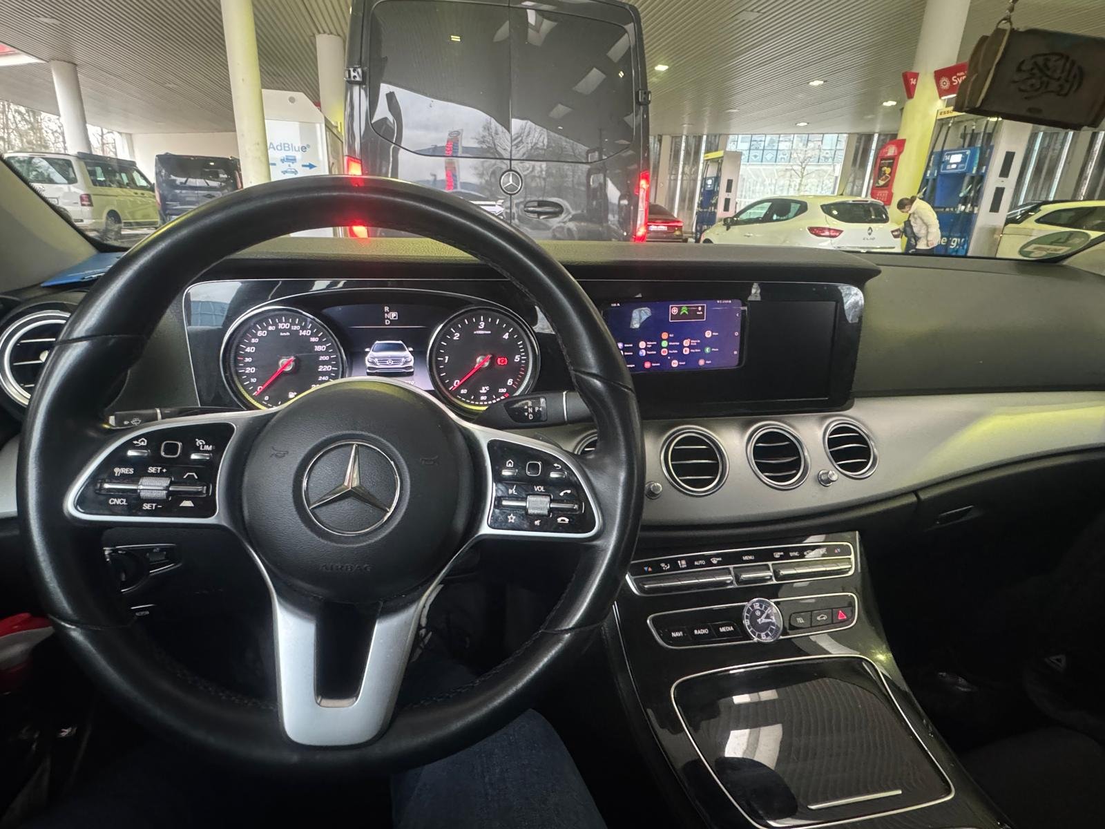 Driver’s view of a Mercedes steering wheel, instruments and central dashboard