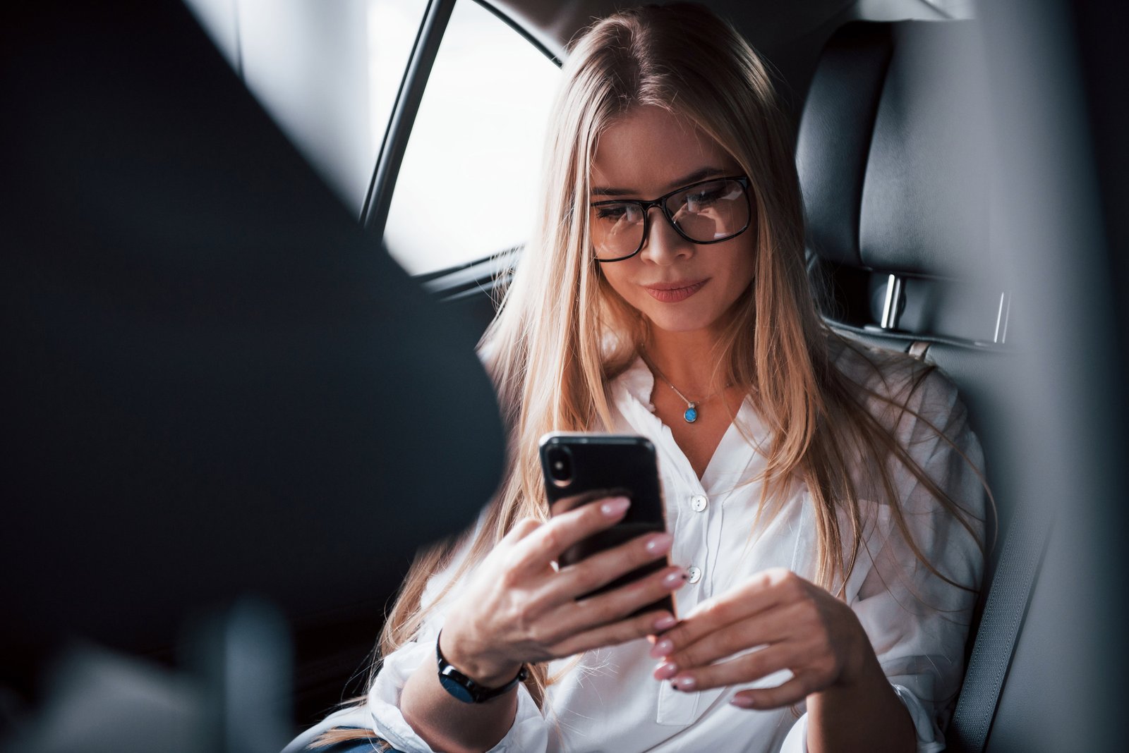 Business traveller working from the rear seat during WEF Davos transport