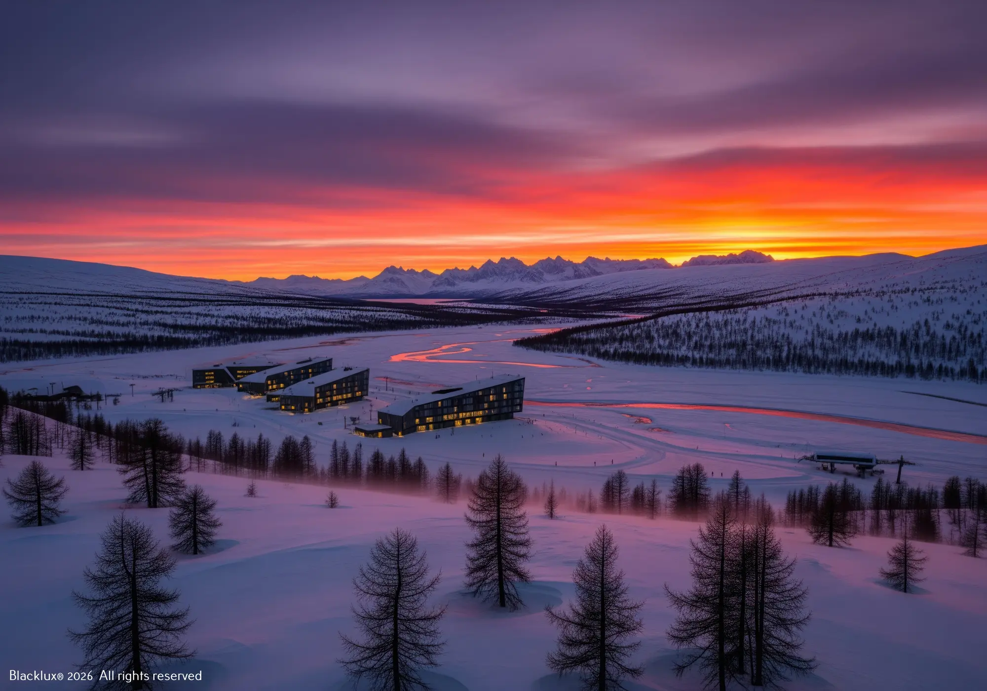 Snow-covered valley and scattered lodges beneath a vivid orange and purple sky