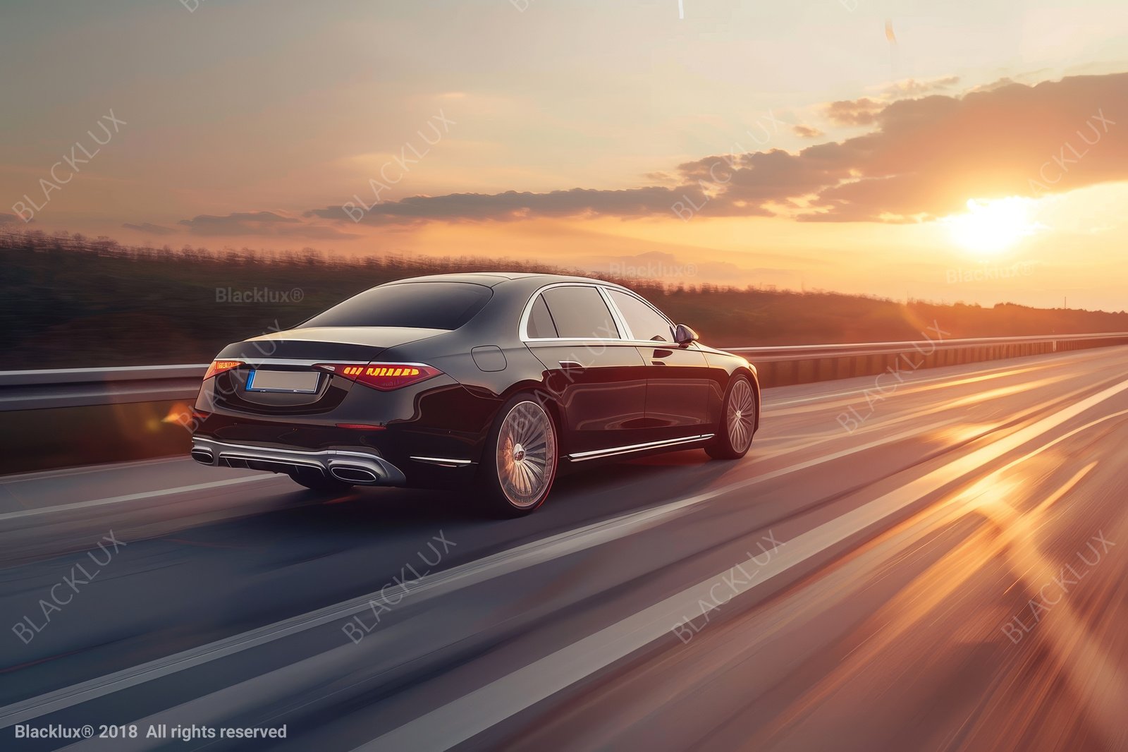 Rear three-quarter view of a black sedan on a road under a warm sunset sky