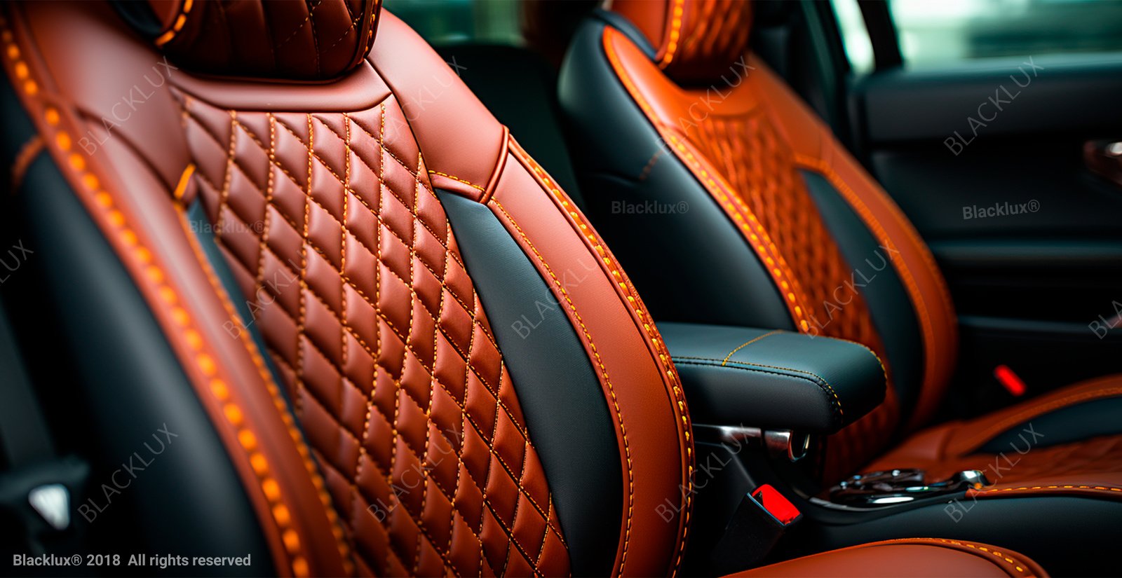 Close detail of quilted copper-coloured and black leather vehicle seats