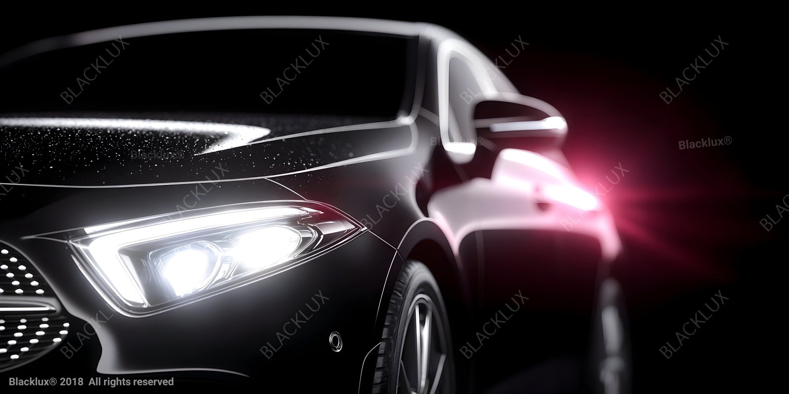 Front quarter of a dark car with bright headlight and pink reflected light