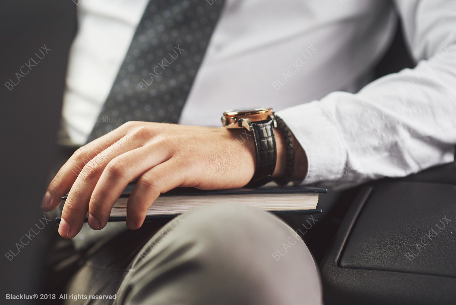 Close-up of a business traveller's hand writing notes inside a car