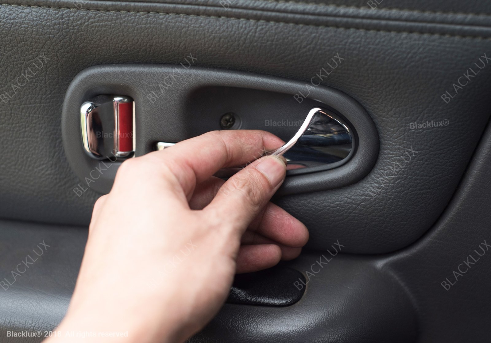 Close-up of a hand operating an interior car-door handle