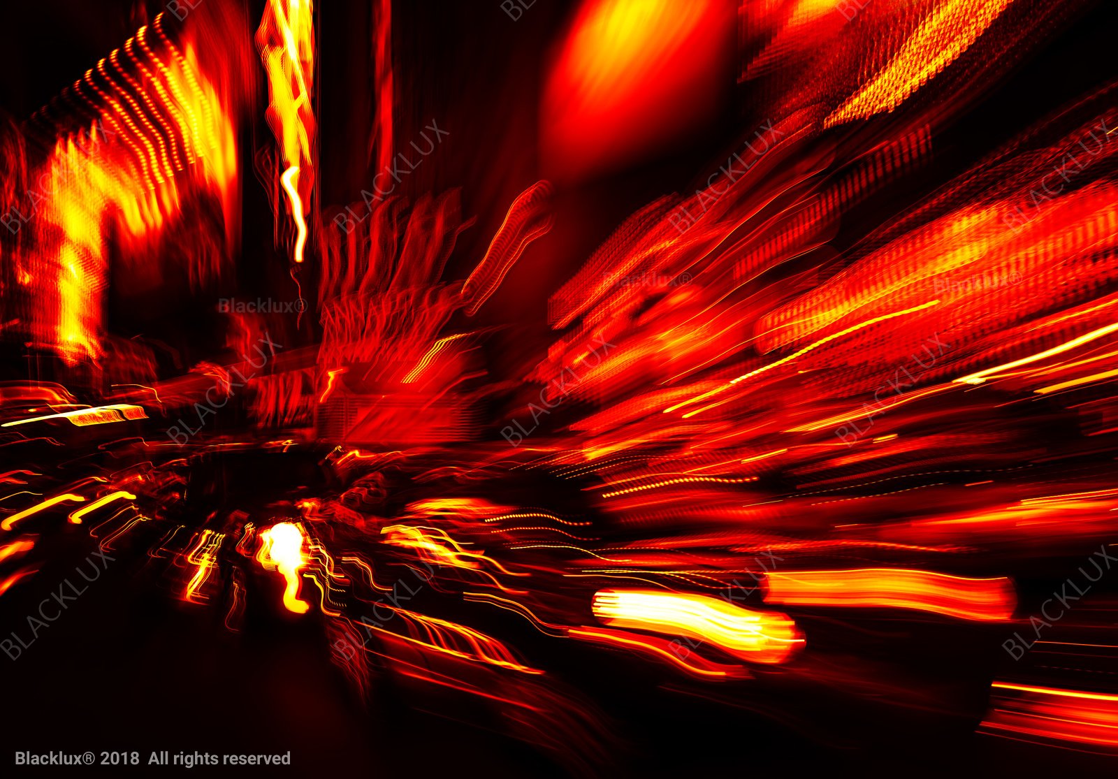 Abstract red and amber city-light trails photographed with intentional night motion blur