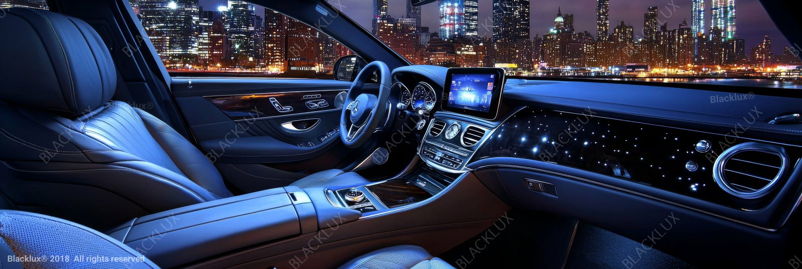 Wide car-interior illustration with dark seats, blue dashboard lighting and a night skyline outside