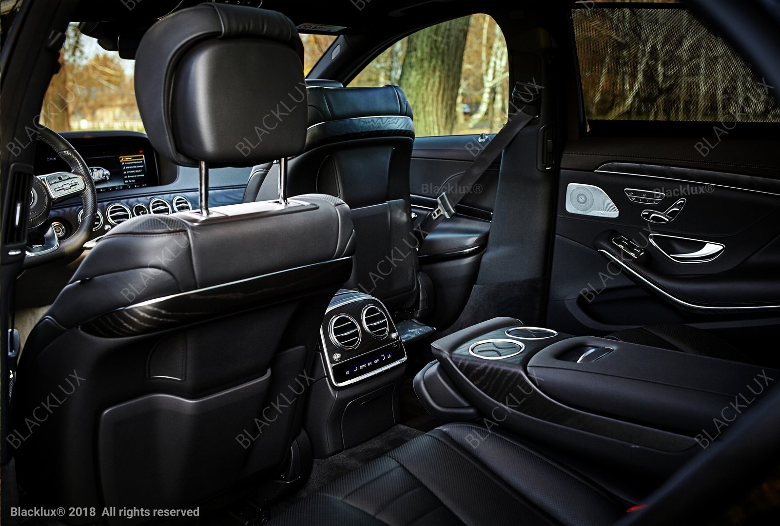 Black leather passenger seats and headrests inside a spacious dark vehicle cabin