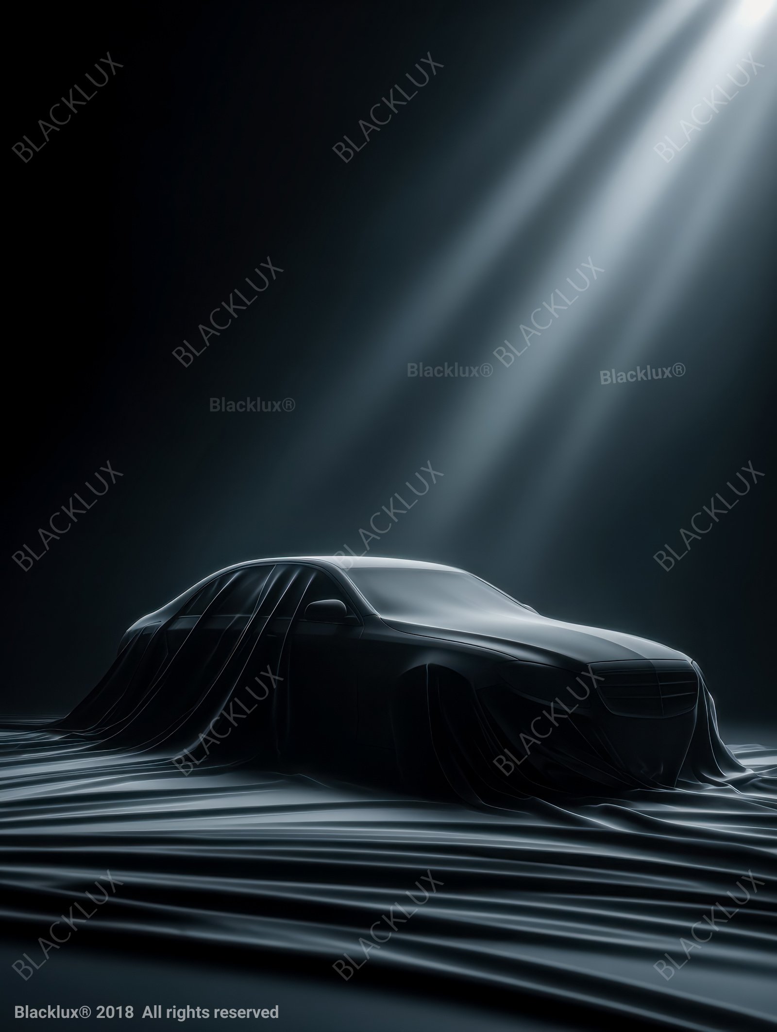 Black sedan partly covered by dark fabric beneath a diagonal studio spotlight